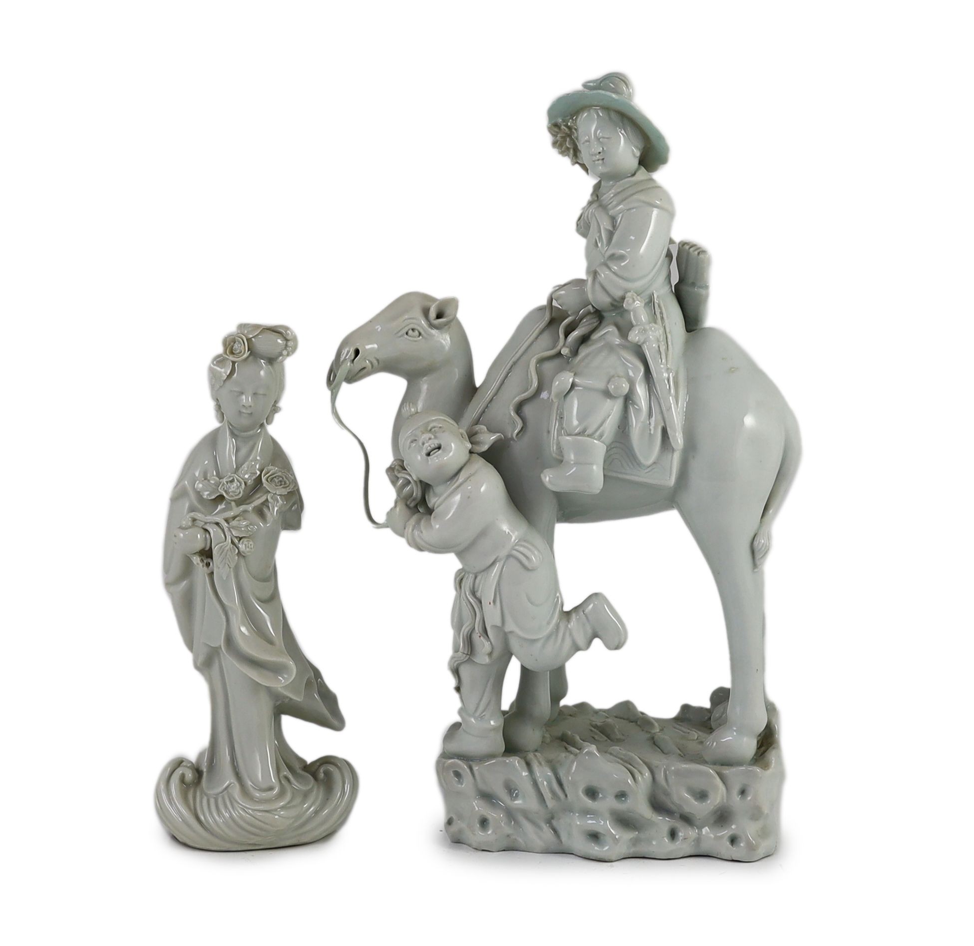 A Chinese blanc-de-chine group of Hua Mulan being led upon a camel, and a similar figure of Guanyin, Dehua kilns, both Republic period, Tallest 31 cm